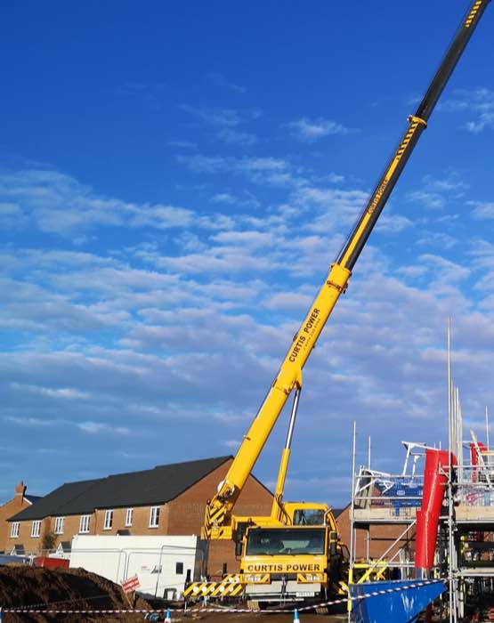 Curtis Power crane doing a timber frame lift